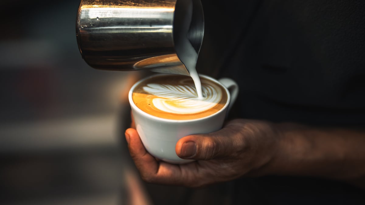 Barista pouring coffee